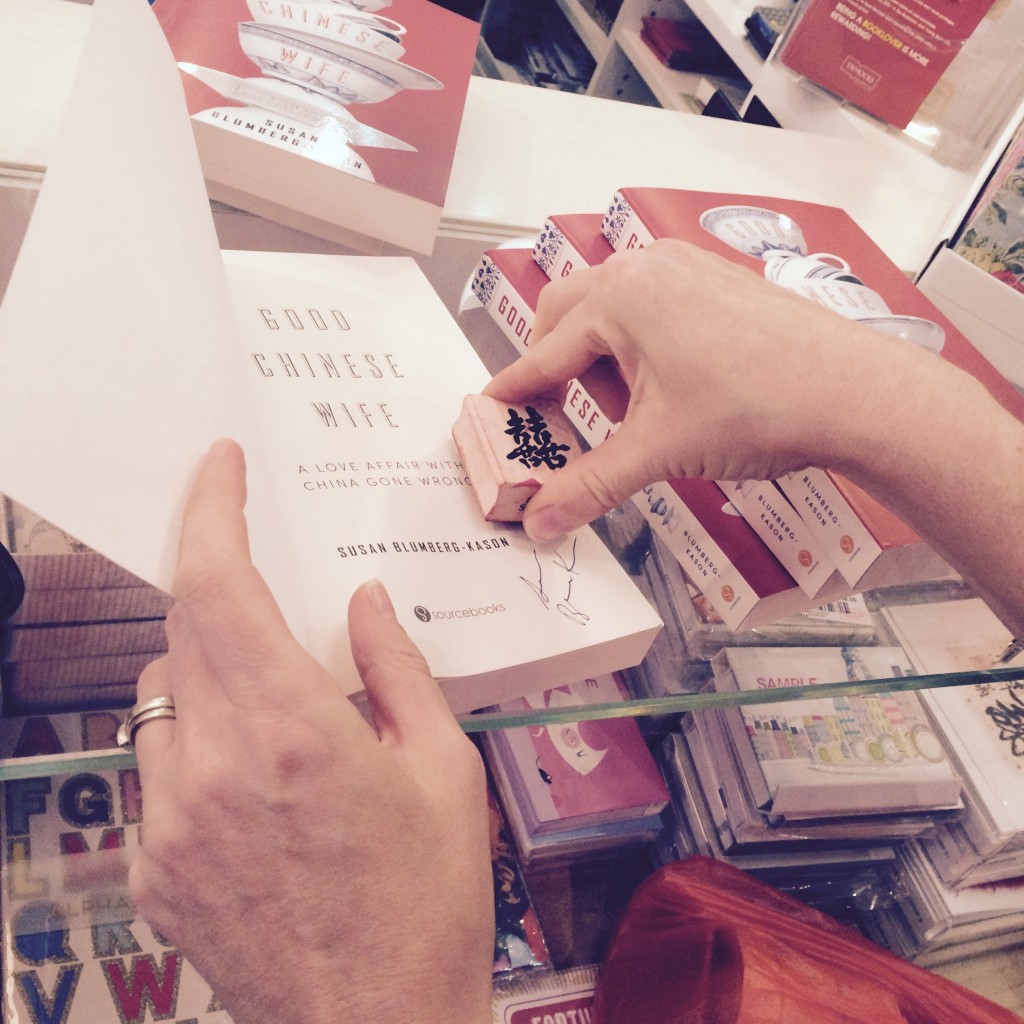 Signing and stamping books at Dymock's
